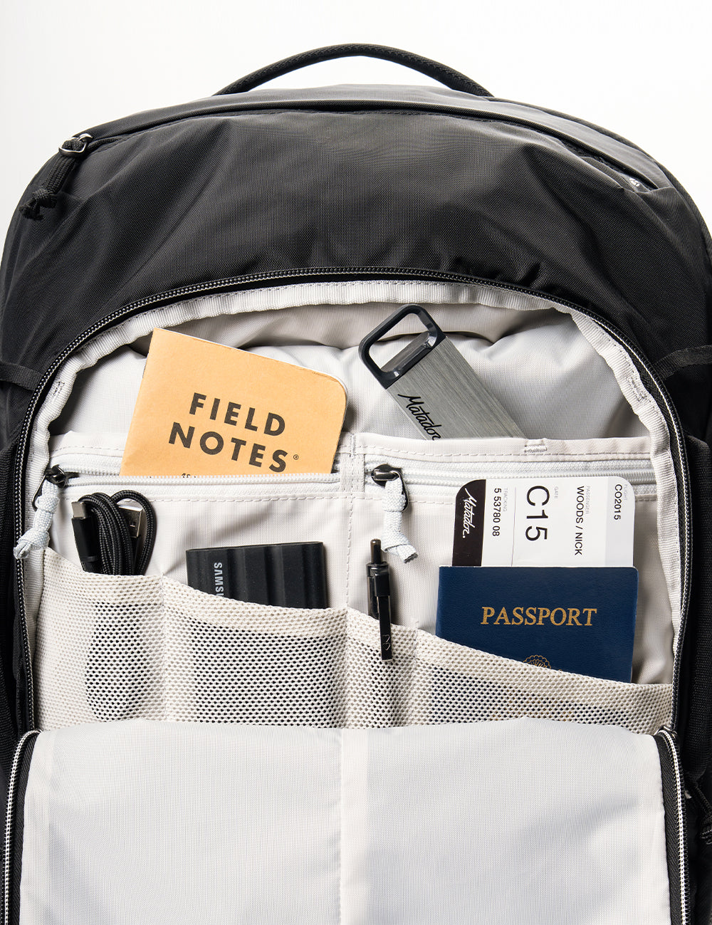 backpack pocket organization with passport, cords, and notebook