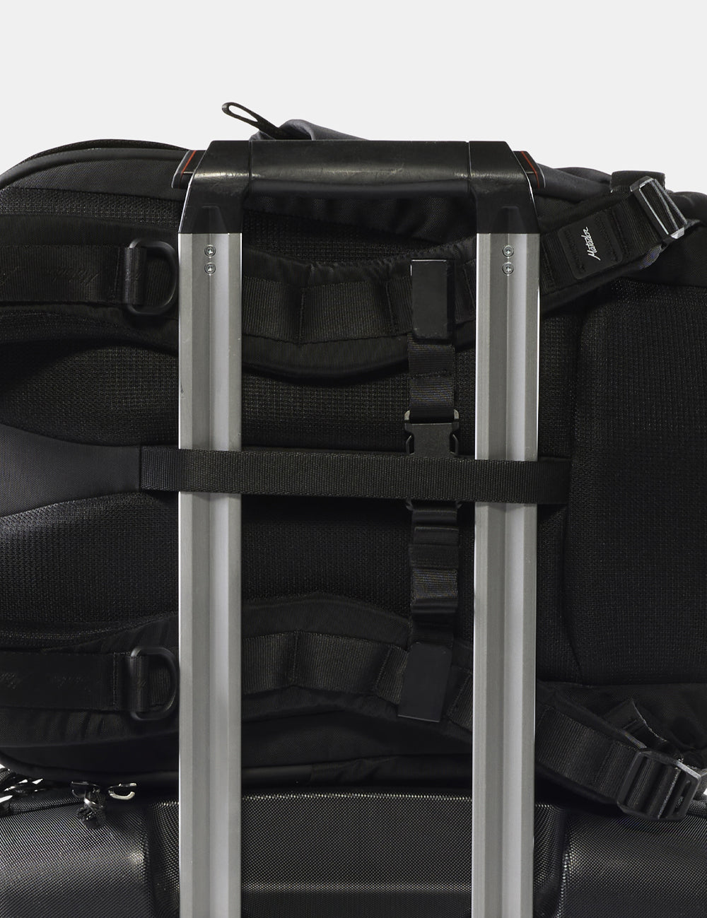 close up view of backpack on rolling luggage handle