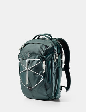 Green backpack with white accents on a light gray background