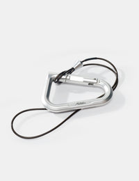 Silver carabiner with a black cord on a white background
