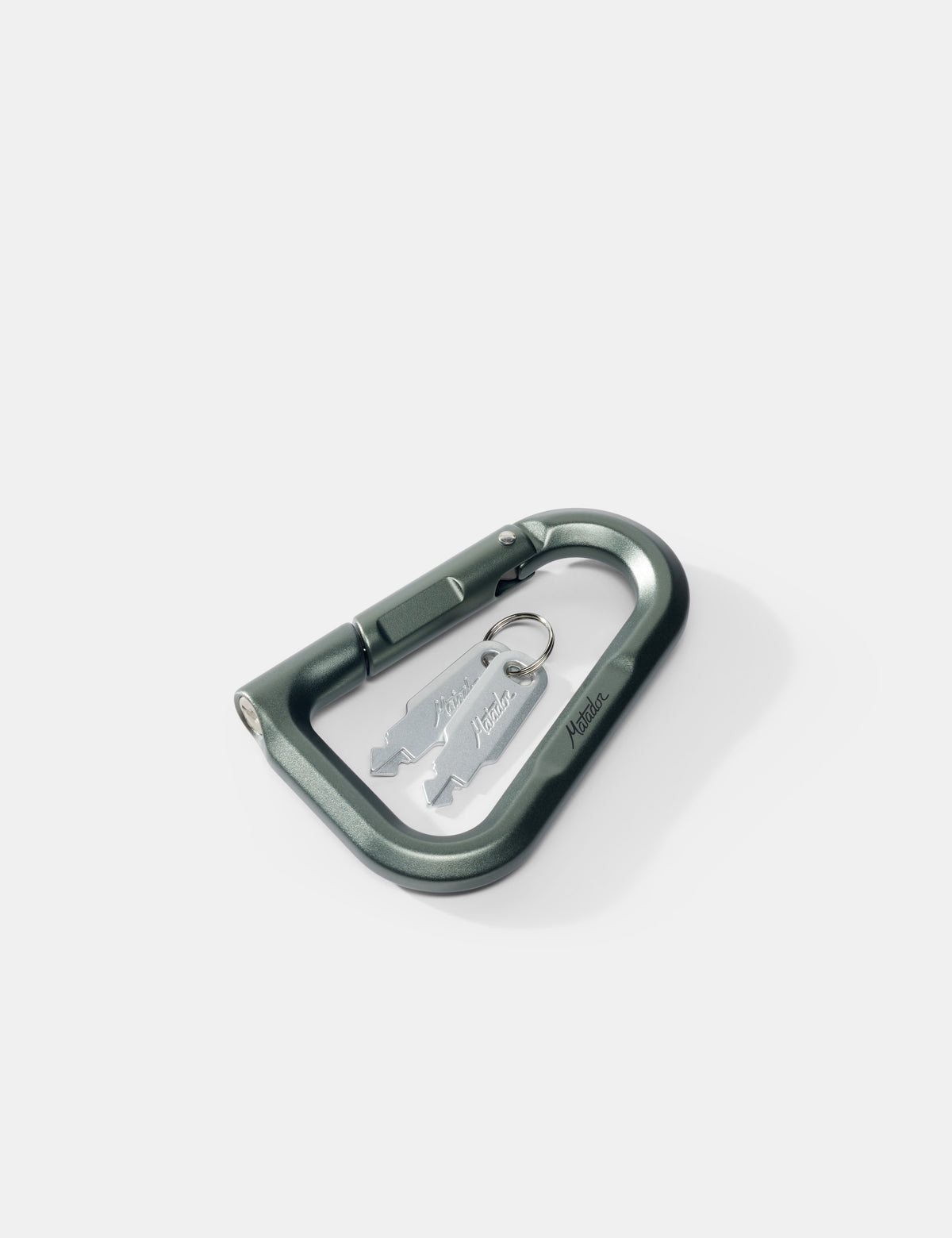 Green carabiner with keys on a white background