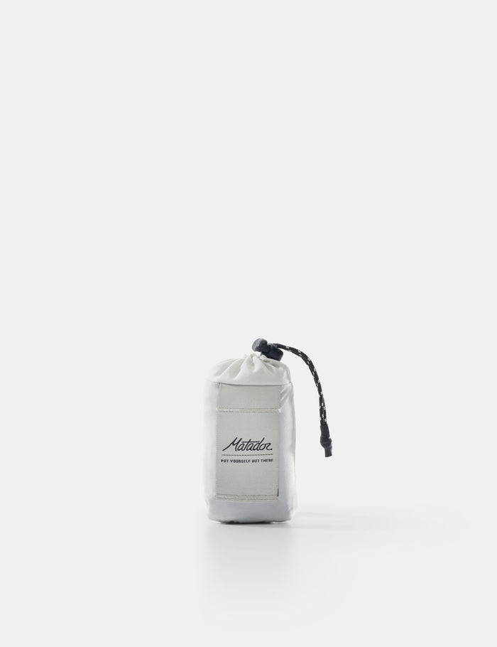 White drawstring bag with black branding on a white background