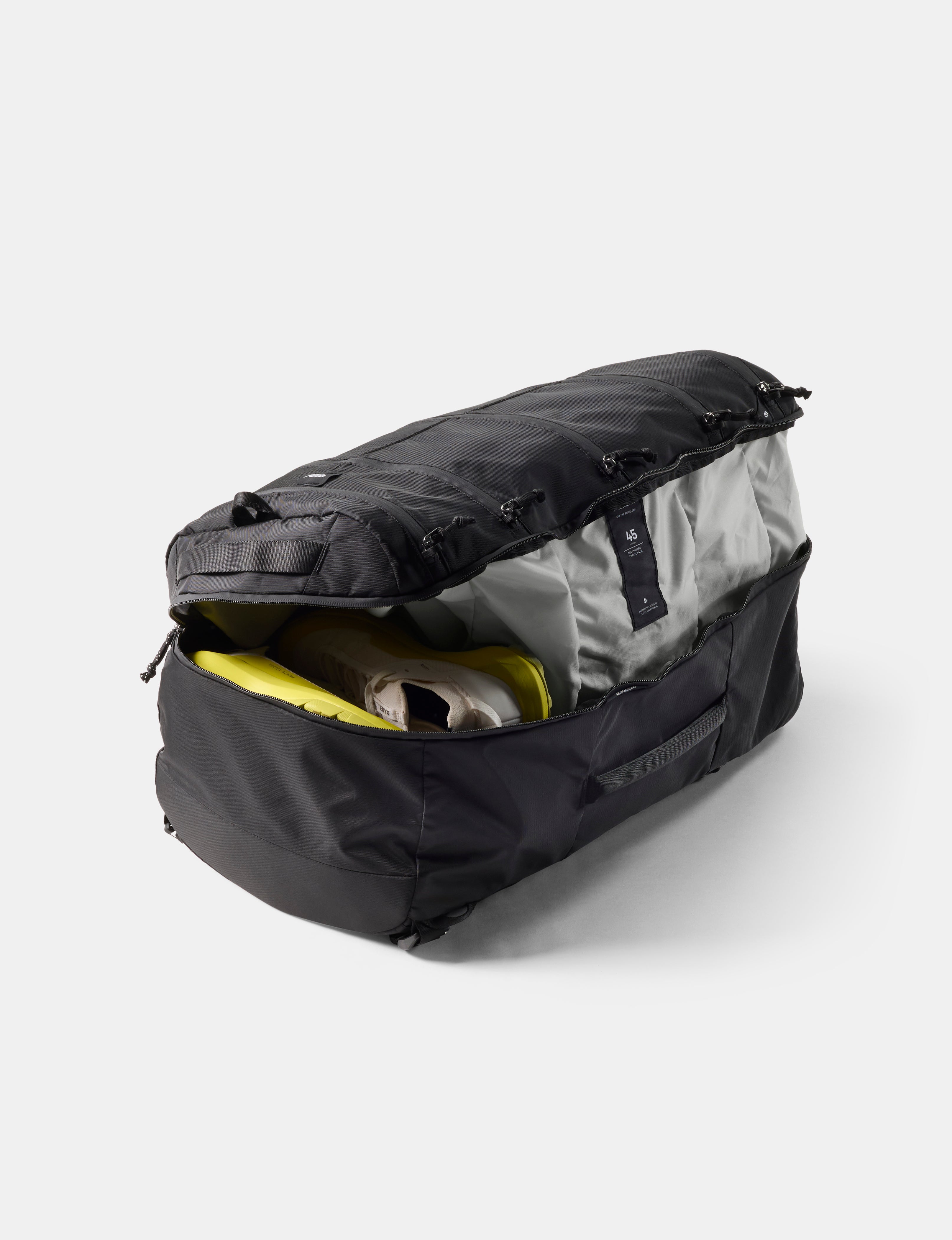 Black duffel bag with open top showing gray interior on a white background