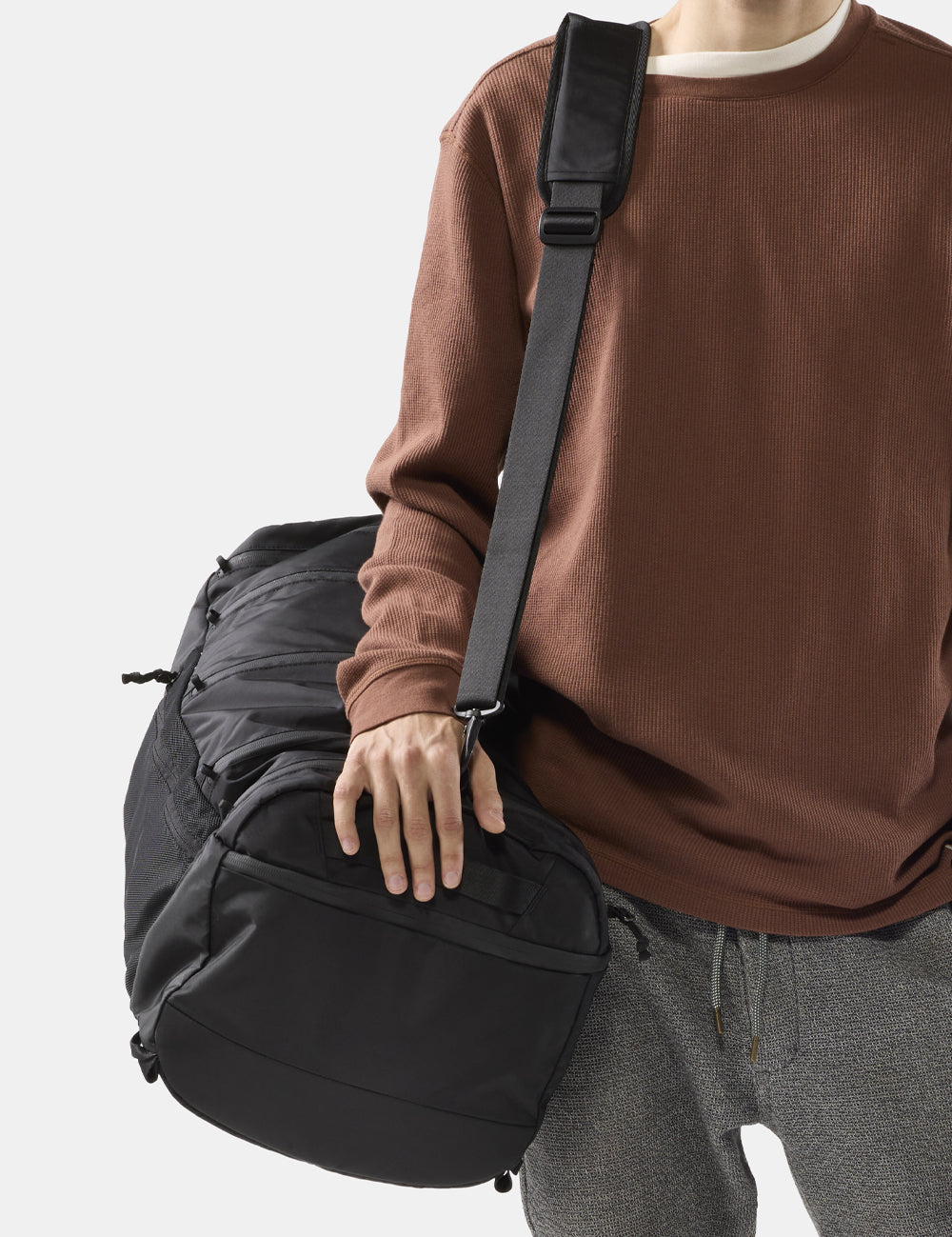 person with black duffel bag