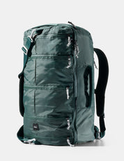 Green backpack with multiple zippers on a white background