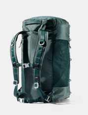 Green backpack with multiple straps on a white background