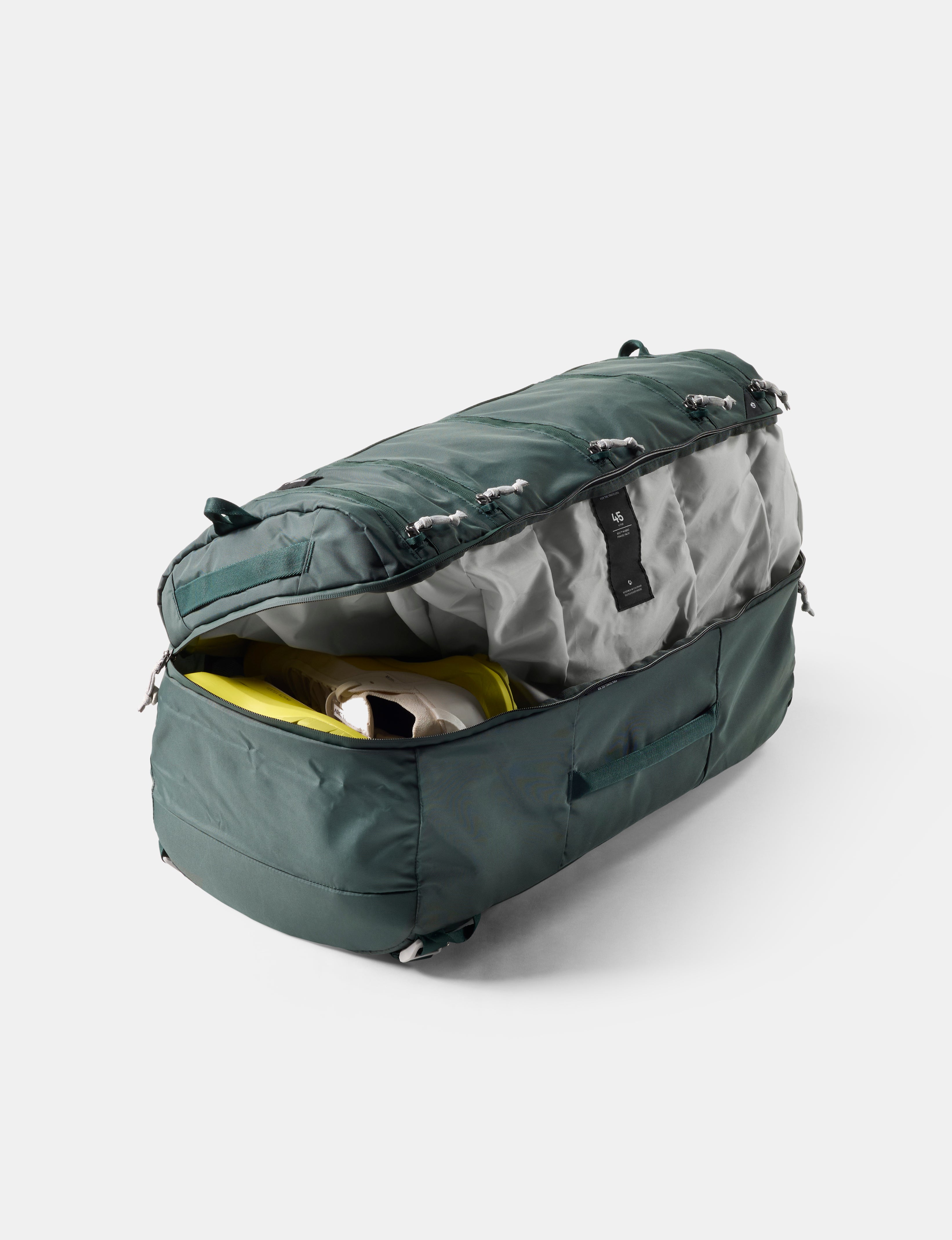 Green and gray duffel bag on a white background
