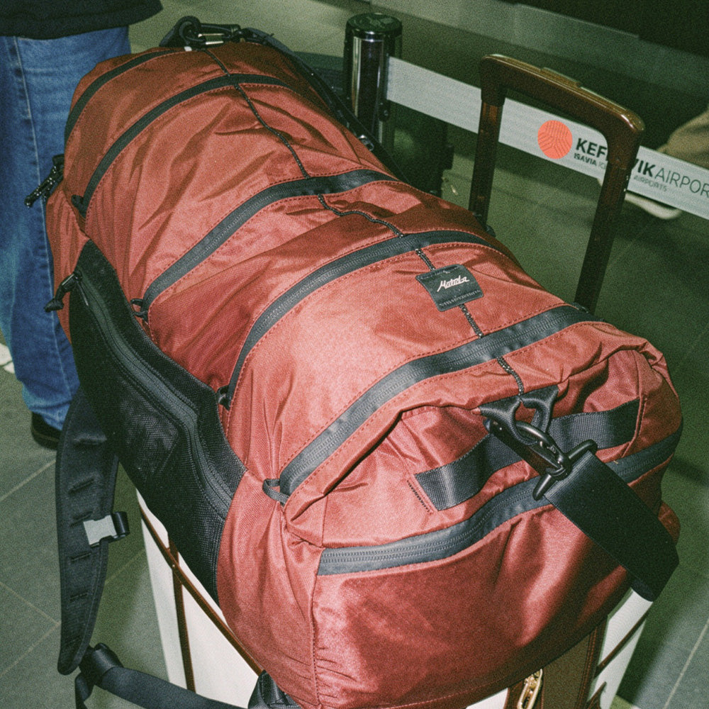 garnet duffel on airport luggage