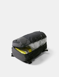 Black duffel bag with open interior on a white background