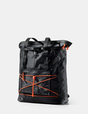 Black backpack with orange accents on a light gray background