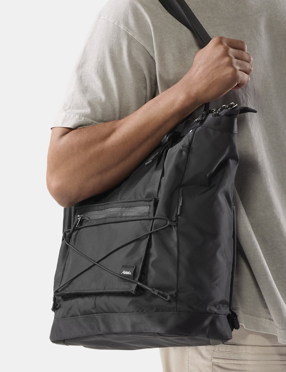 black tote on persons shoulder