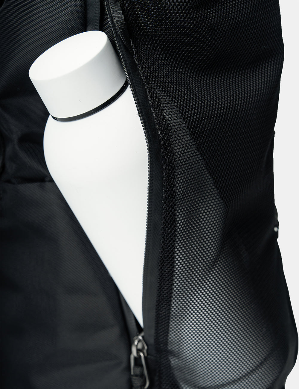 white water bottle in  black see through mesh pocket