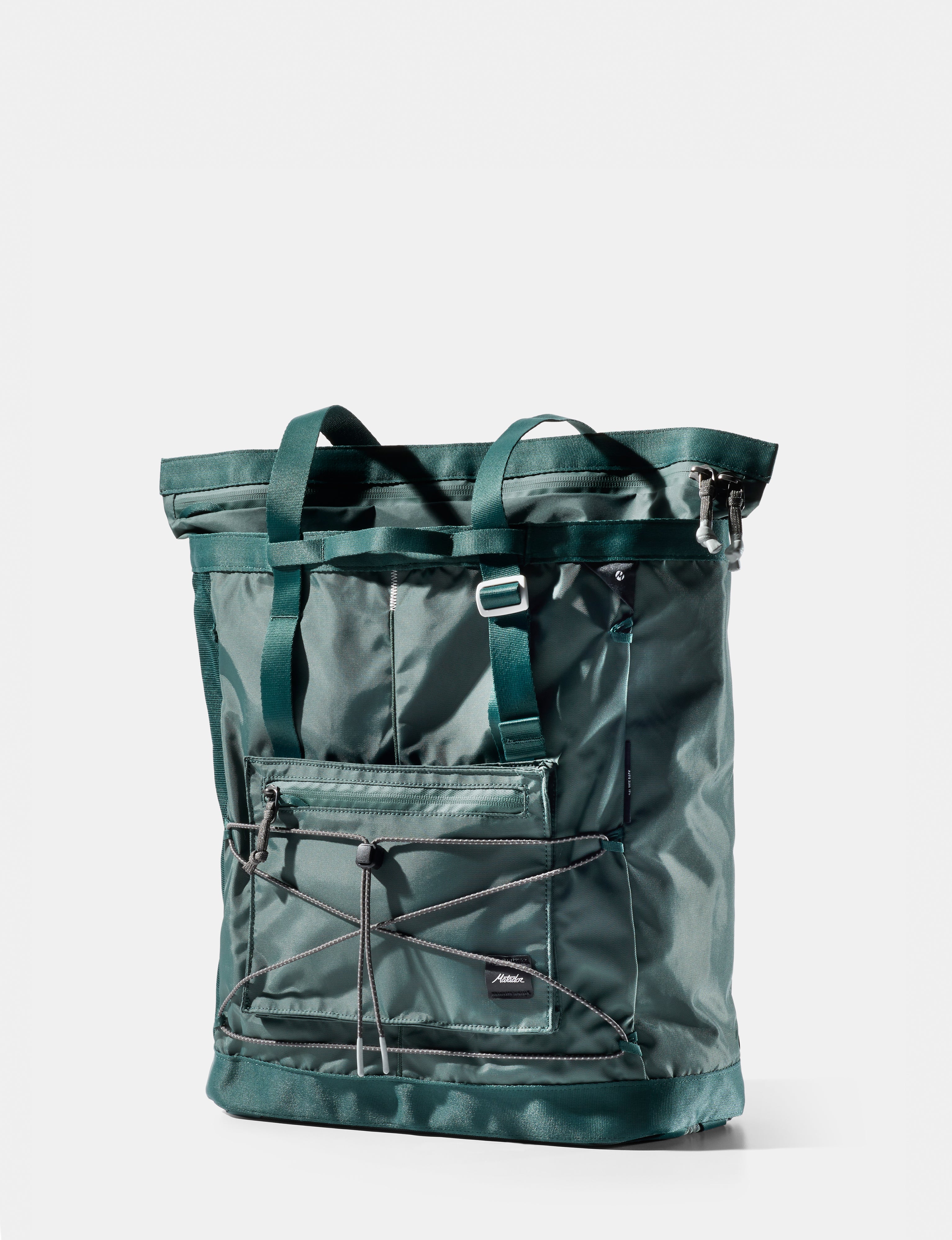 Green tote bag with multiple straps on a white background