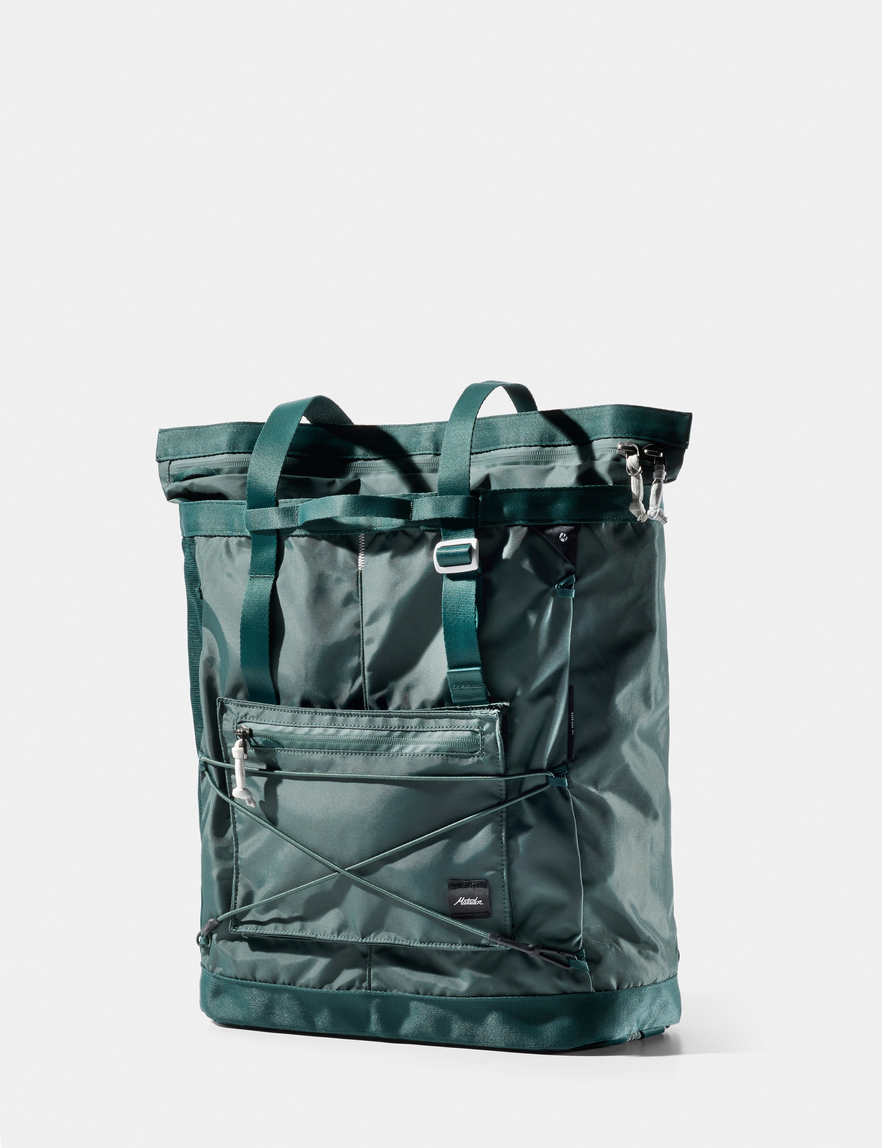 Green tote bag with multiple pockets on a white background