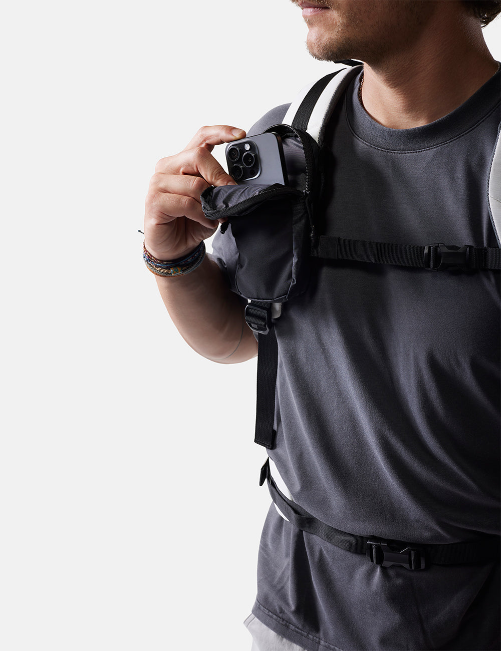 Person wearing a black backpack with a white background