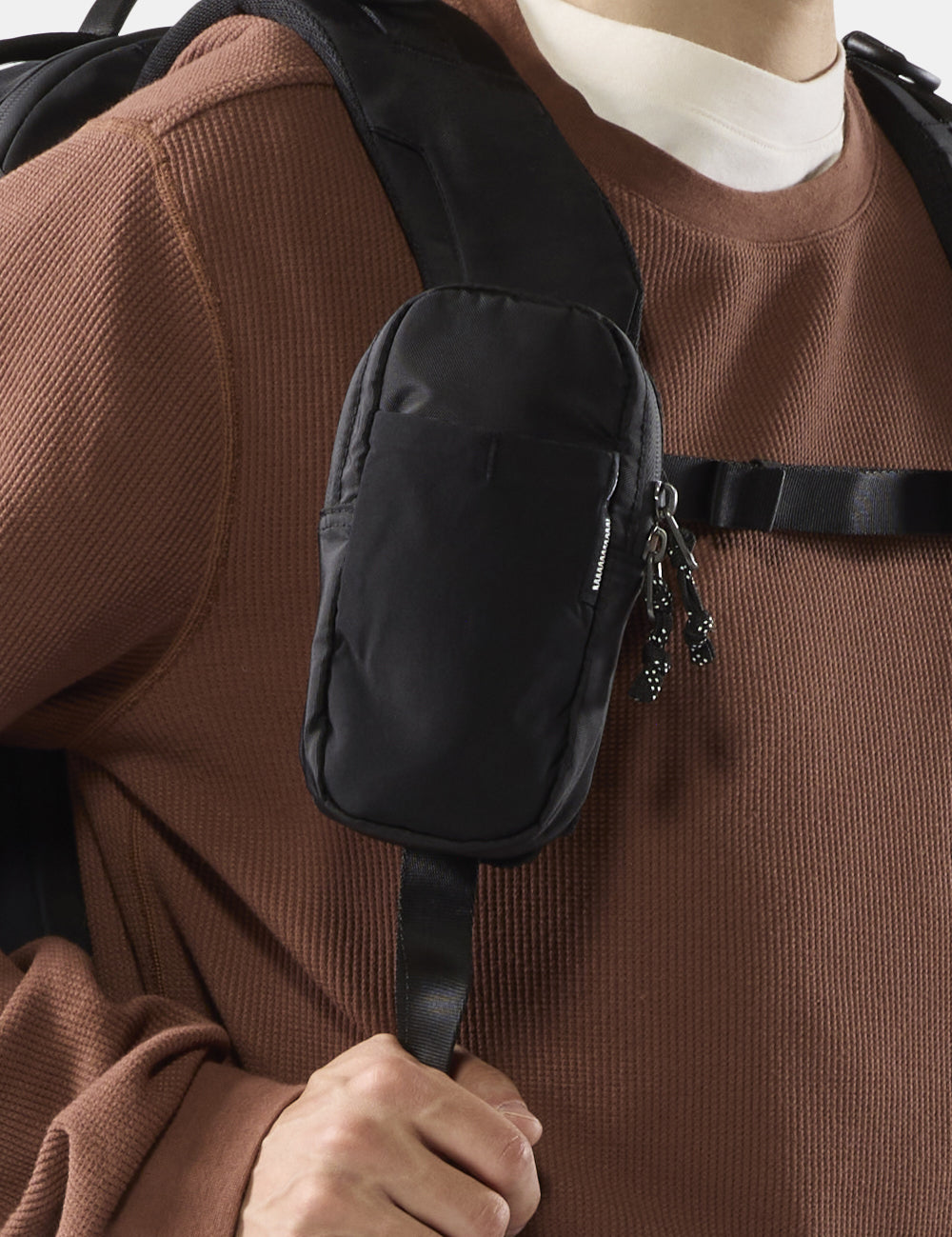 black pocket on black backpack strap