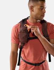 Man wearing a garnet backpack with a white background