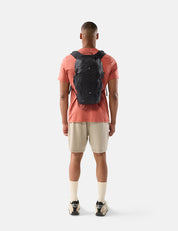 Man wearing a black backpack on a white background