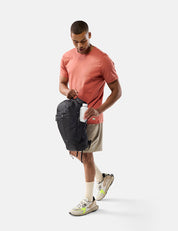 Man holding a black bag on a white background