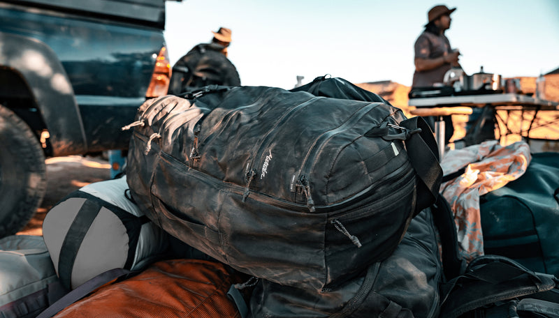 Dusty SEG45 in a pile of bags next to a truck in the desert