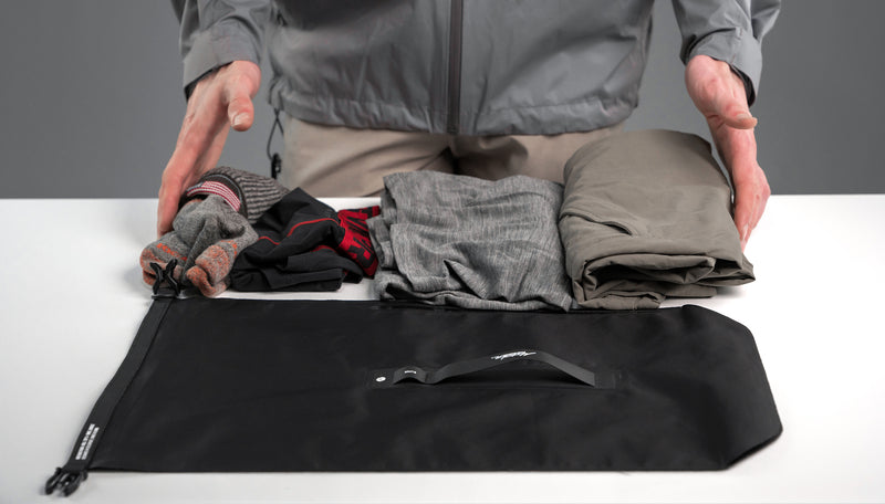 Dry Bag laid out next to folded clothing