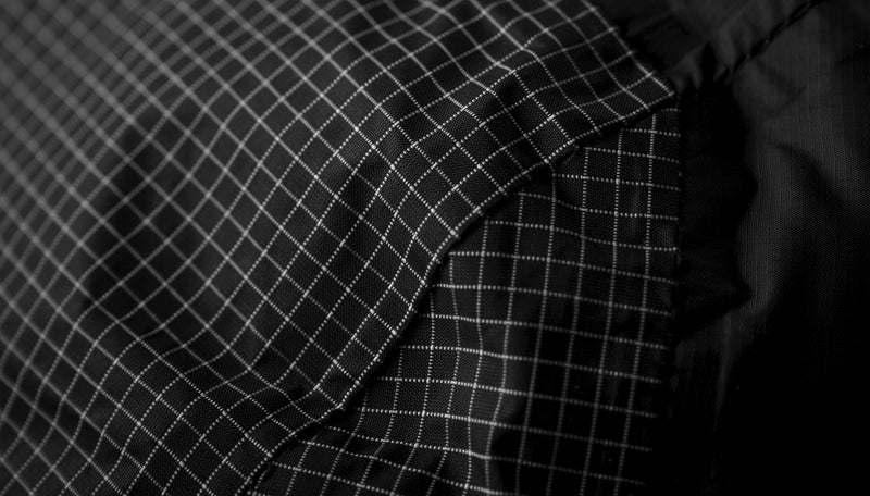 Close up view of black fabric with subtle white grid