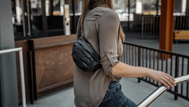Woman in city, wearing On-Grid hip pack across her back
