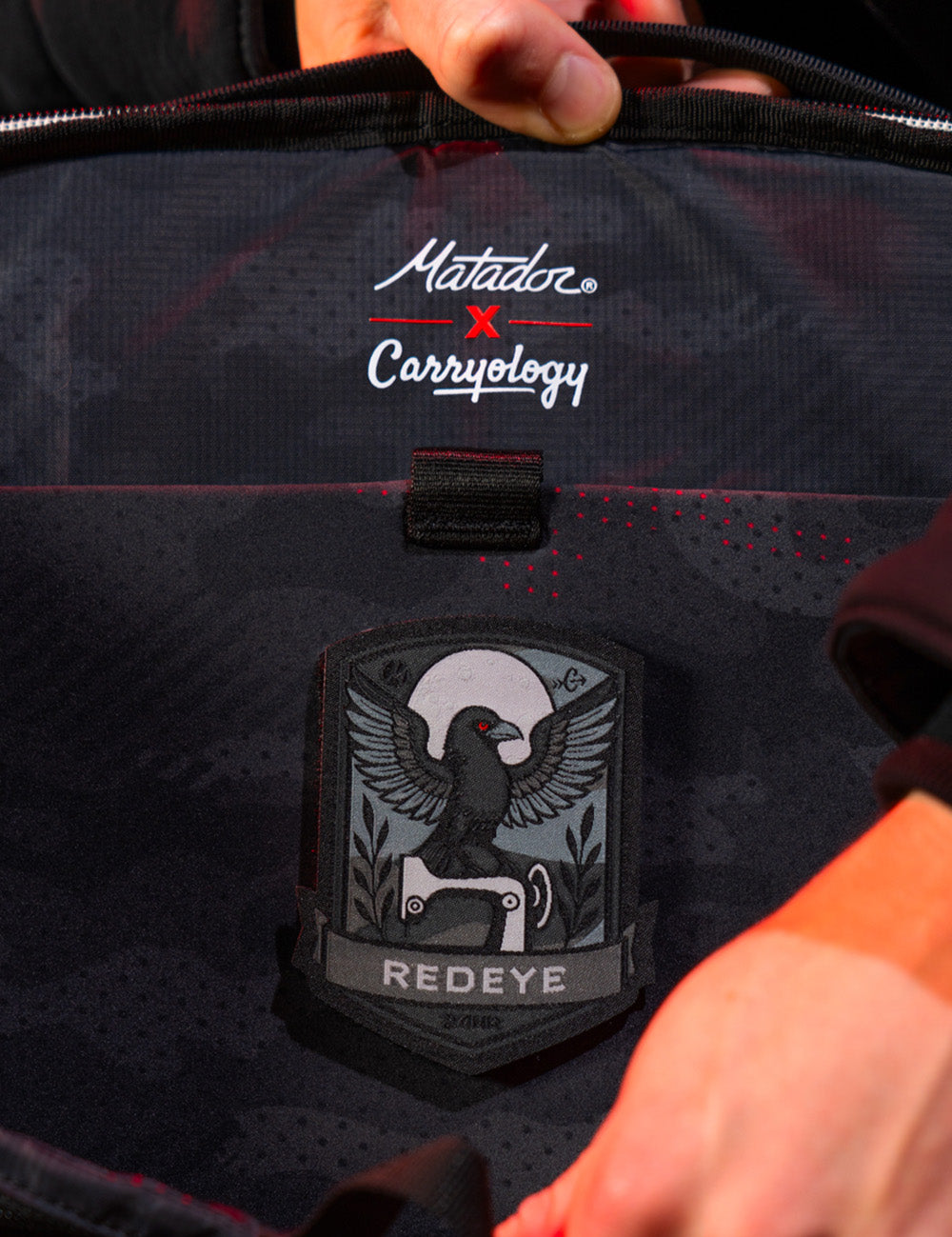 black raven patch on inside of backpack