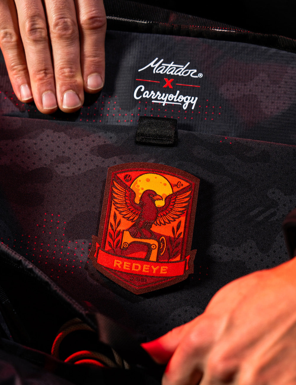 red raven patch detail inside of backpack