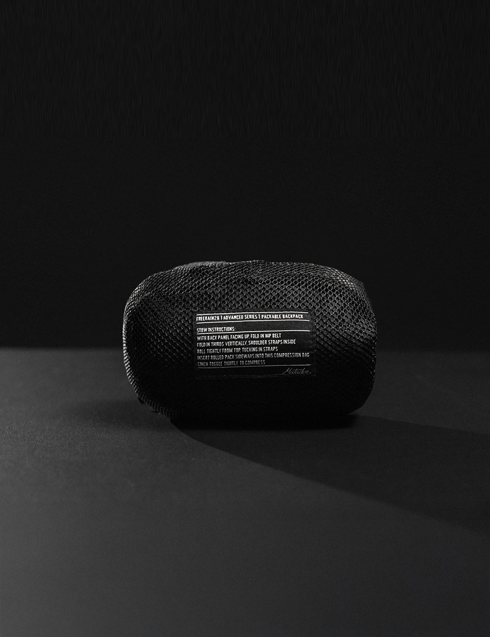 Black mesh pouch with text on a black background