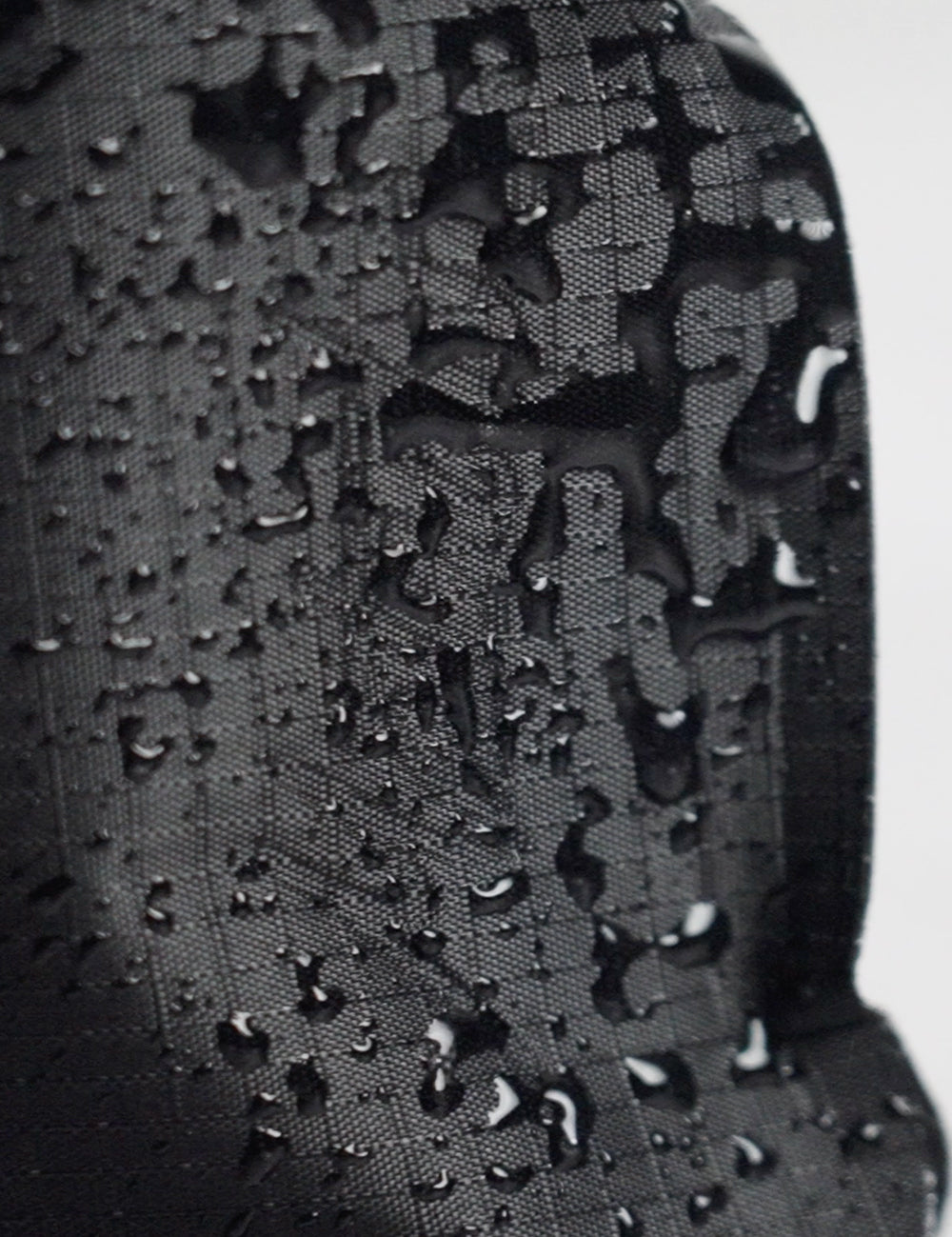 close up view of water droplets on grid fabric