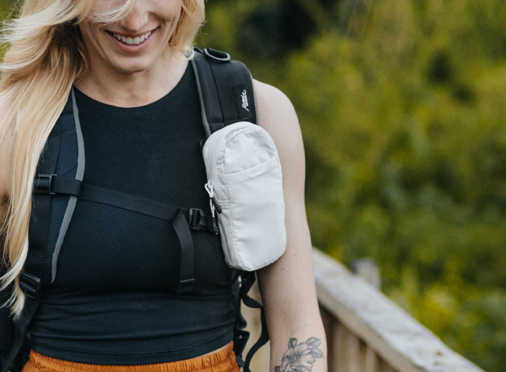 Woman wearing a white speed stash on her black backpack