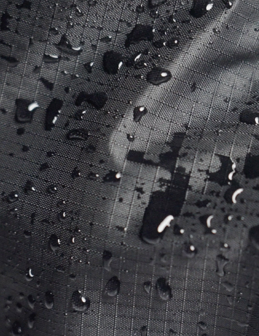 water droplets on black grid fabric