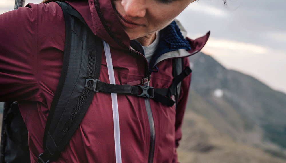 Front view of beast18 sternum strap on woman in maroon jacket
