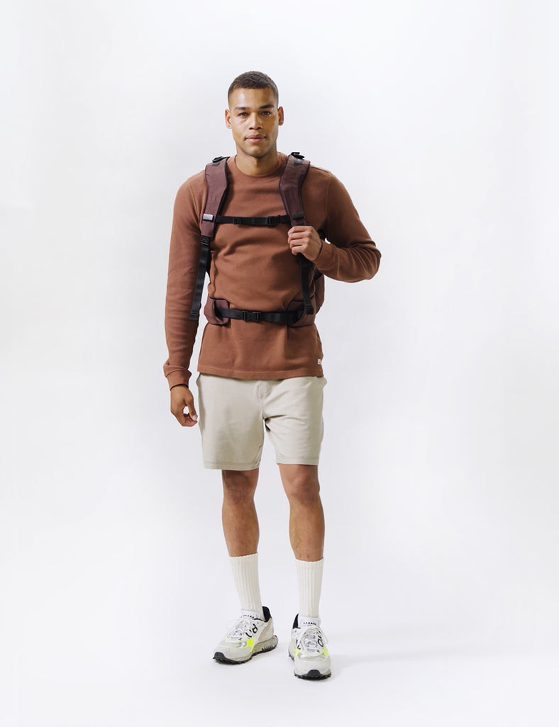 video of man wearing garnet backpack