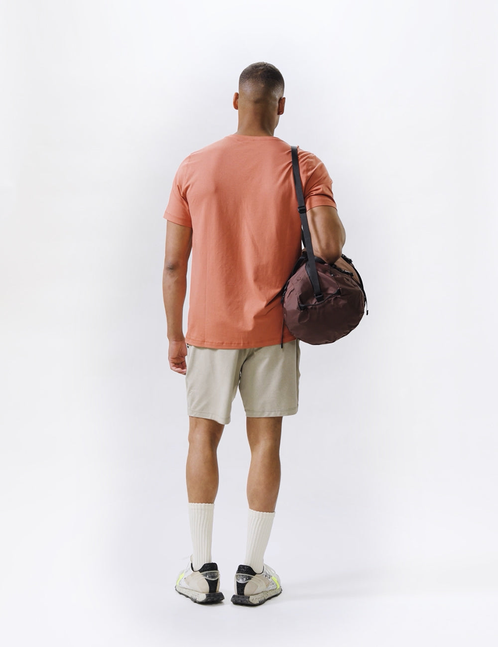 video of man wearing garnet duffel