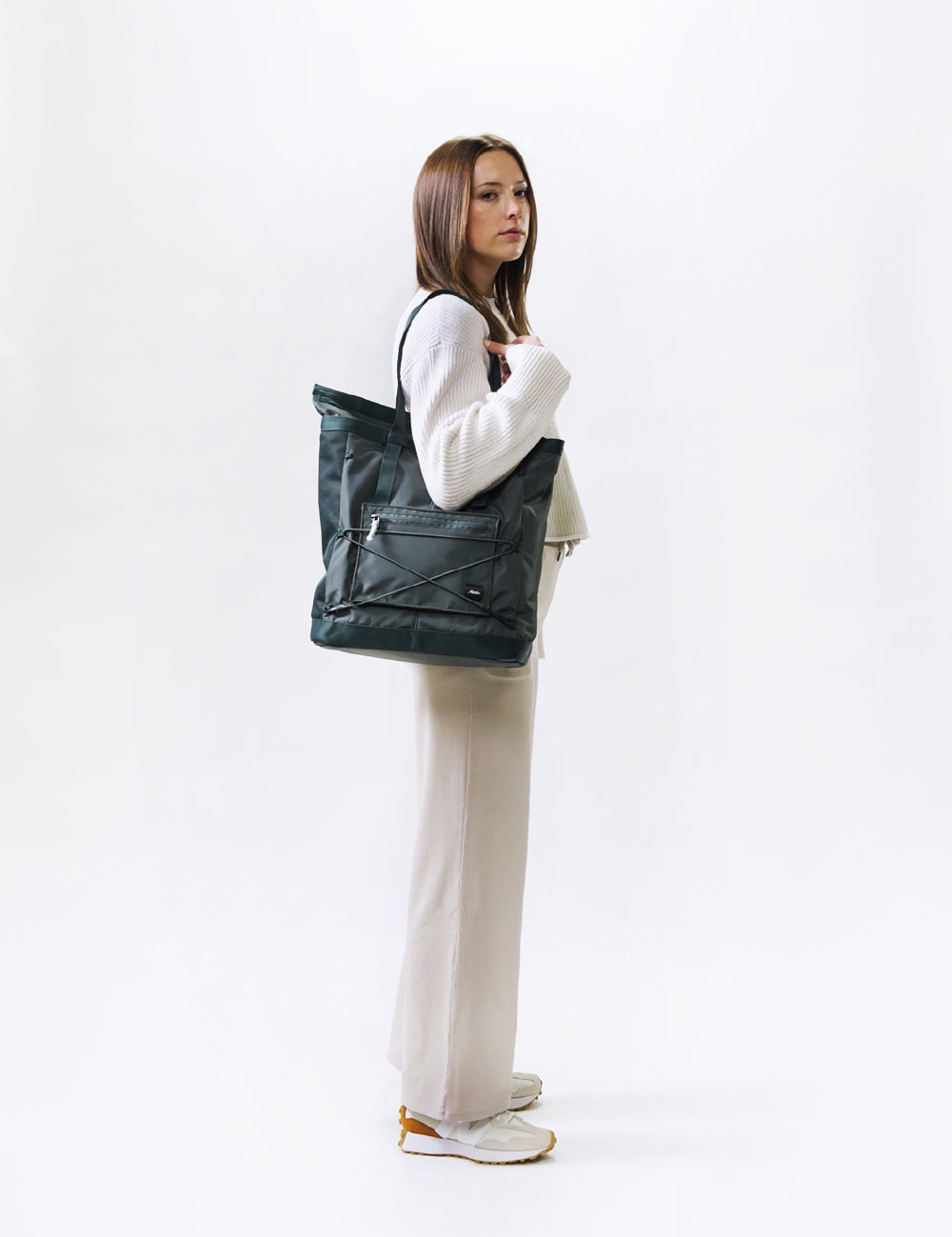 video of woman wearing juniper tote pack