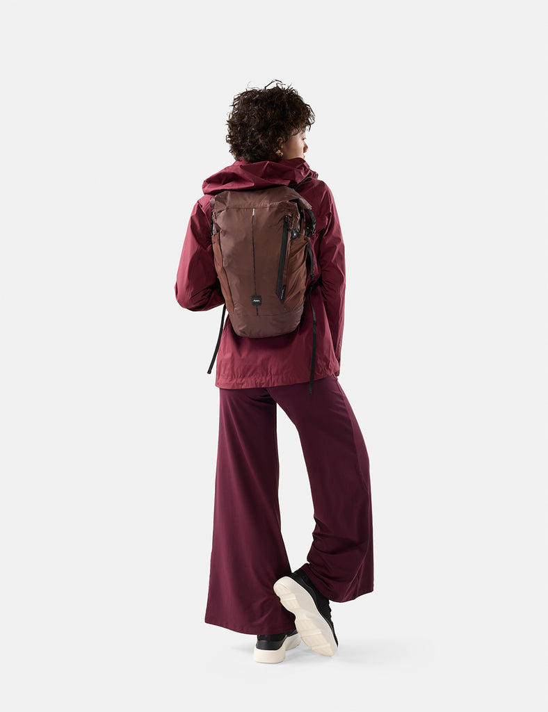 video of woman wearing garnet backpack