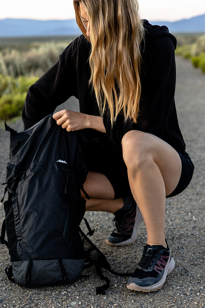 woman packing a backpack in new mexico