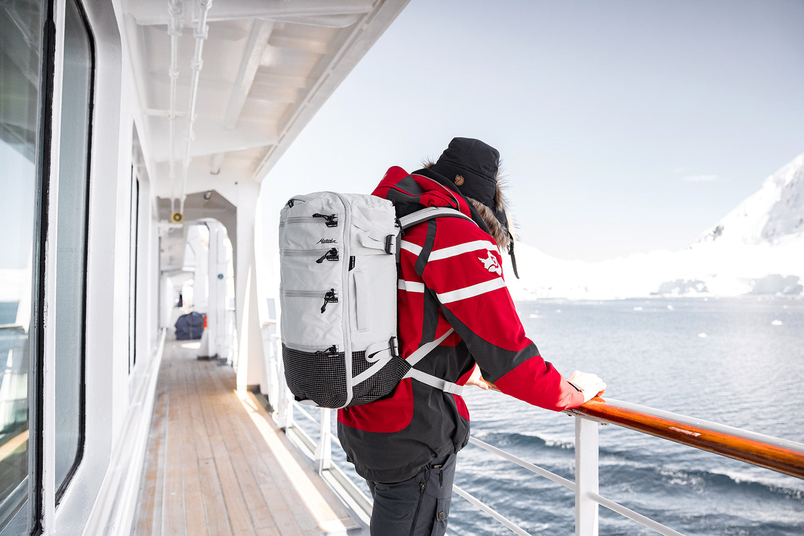 person wearing a white backpack on a cruise ship in antarctica