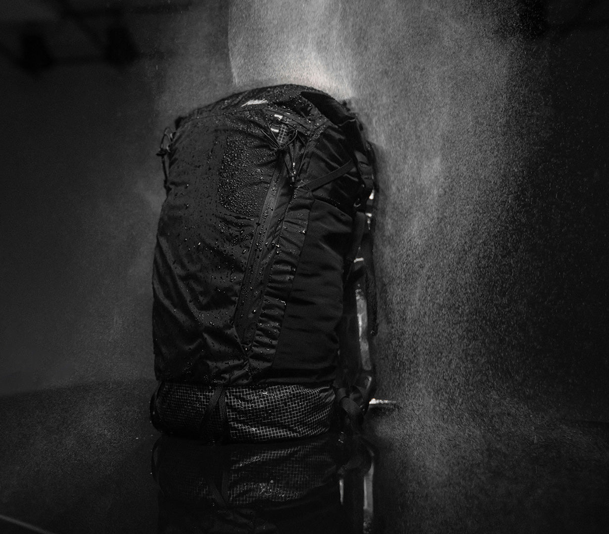 waterproof backpack being tested with rain while keeping the contents dry