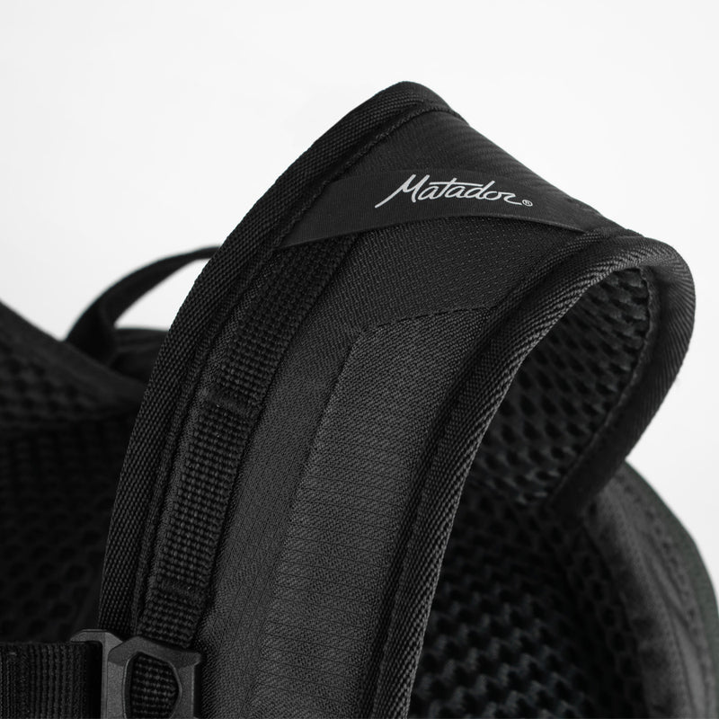 Close up view of Matador logo detail on backpack strap