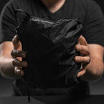 Man holding partially packed down duffle