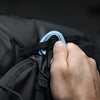Close up view of hand attaching carabiner to Beast28 gear loop