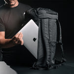 Man placing an Apple laptop into SEG45 laptop pocket