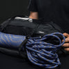 Blue climbing rope attached to duffle