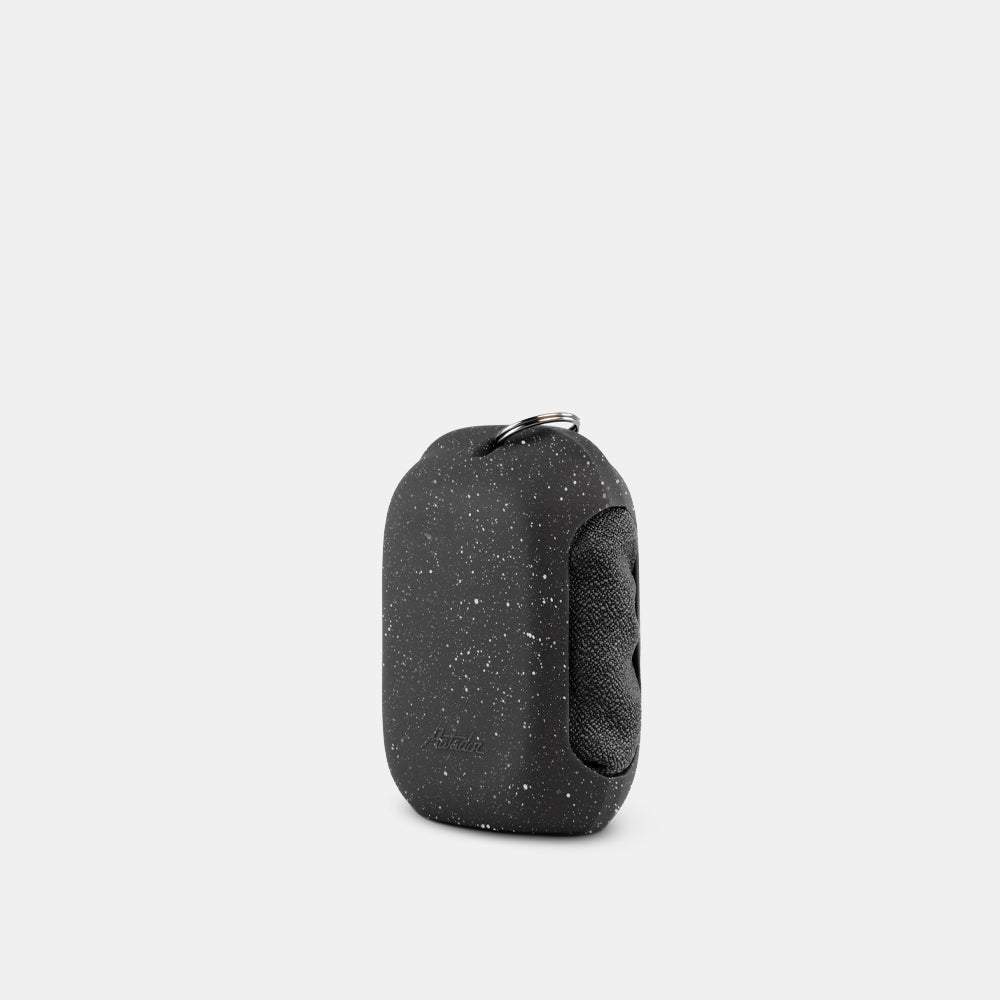 3/4 view of Black Granite NanoDry Trek Towel in silicone case on white background