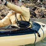 Man in sea kayak wearing cross body hip pack