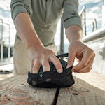 Man taking duffle out of packable pouch