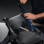 Man strapping down ice axe on backpack